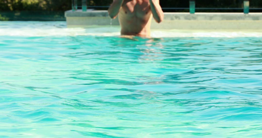 Young man enjoying summer in swimming pool - Free Images, Stock Photos and Pictures on Pikwizard.com