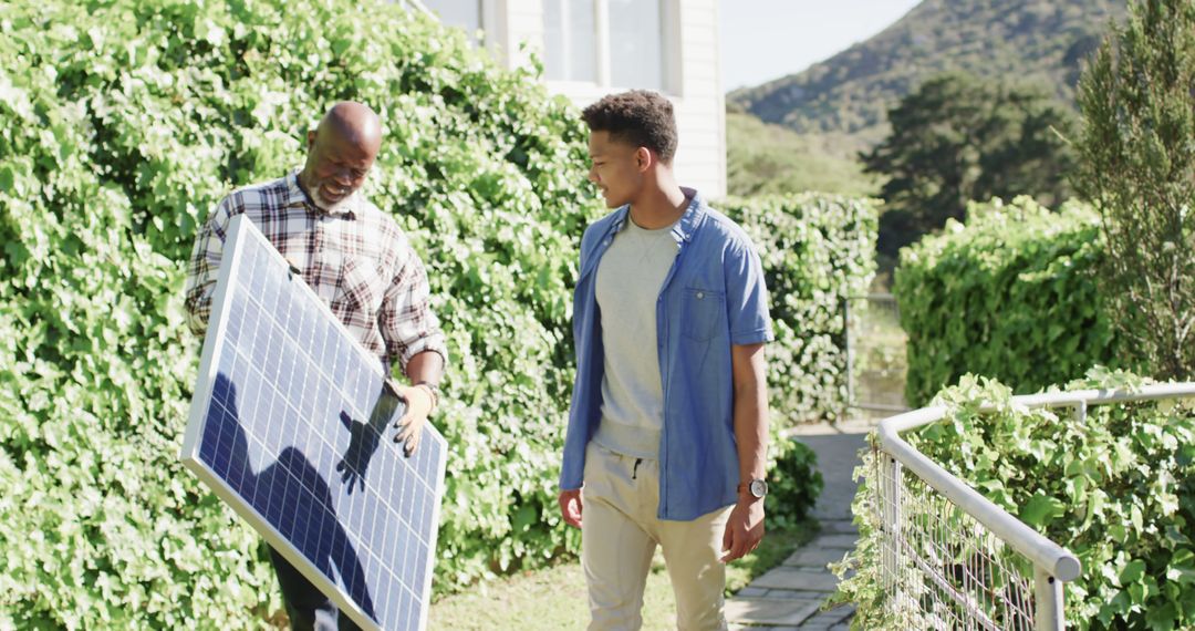 Father and Son Installing Solar Panel in Garden on Sunny Day - Free Images, Stock Photos and Pictures on Pikwizard.com