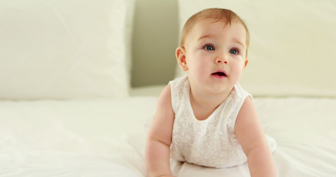 Cute Baby in White Outfit Crawling on Bed - Free Images, Stock Photos and Pictures on Pikwizard.com