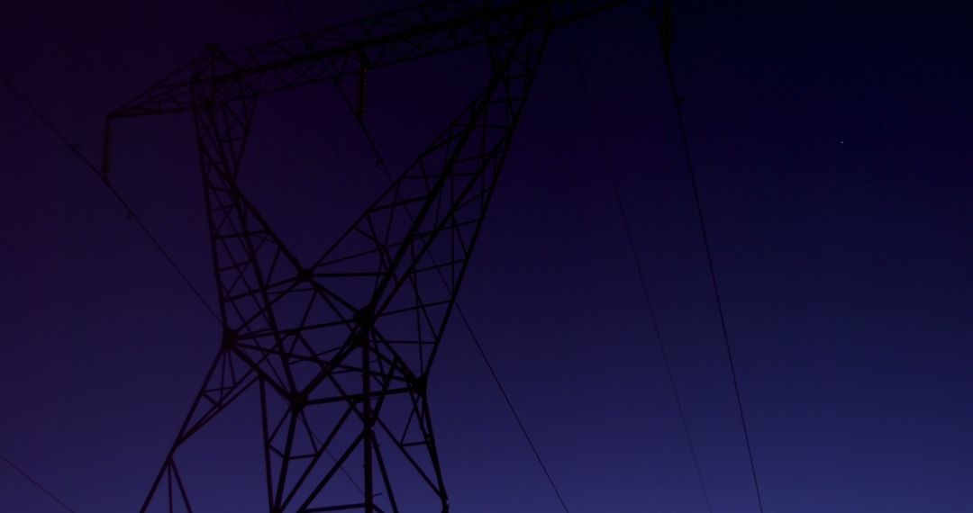 High Voltage Electric Tower Against Midnight Blue Sky - Free Images, Stock Photos and Pictures on Pikwizard.com