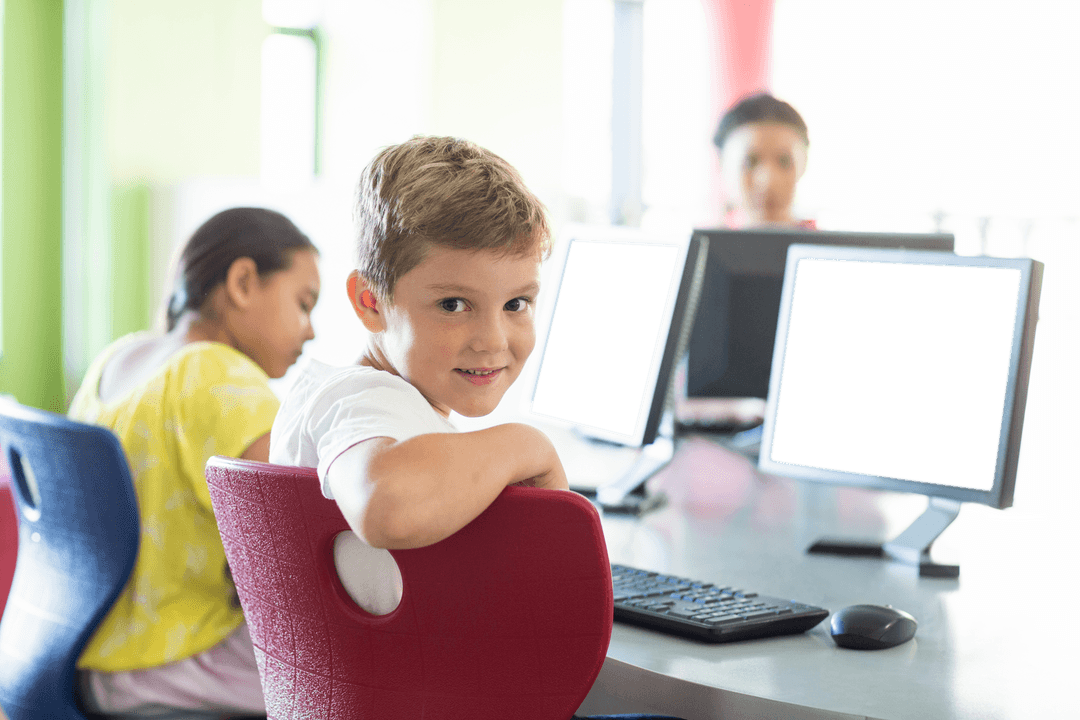 Portrait of Smiling Boy in Classroom with Transparent Computers - Download Free Stock Images Pikwizard.com