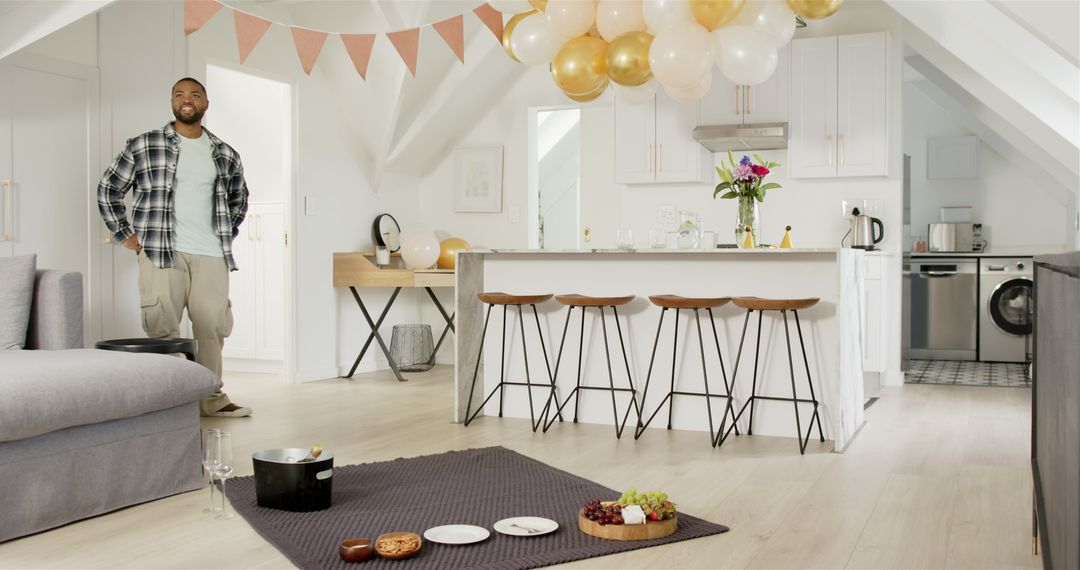 Man Preparing Anniversary Party with Food and Balloons