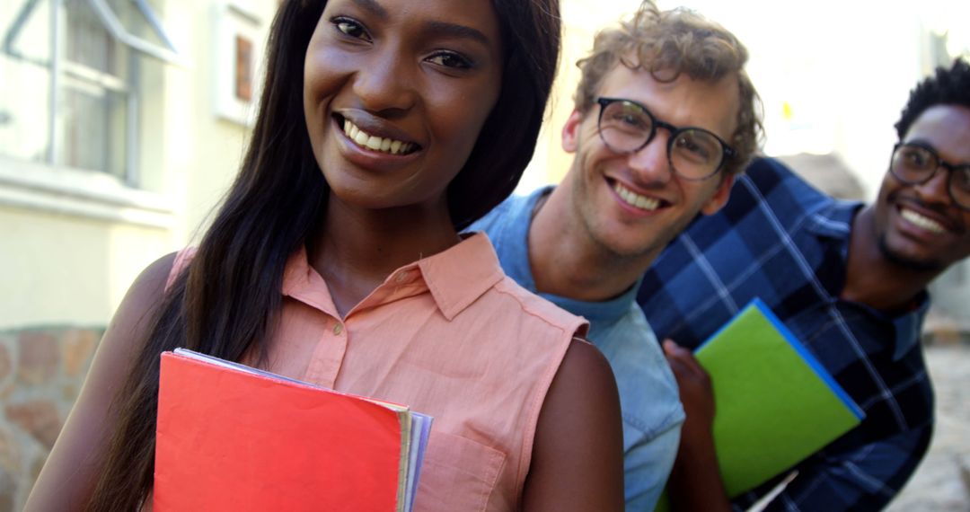 Smiling Diverse Students Holding Notebooks Outdoors - Free Images, Stock Photos and Pictures on Pikwizard.com