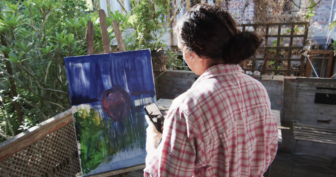 Woman Painting Abstract Art on Canvas Outdoors - Free Images, Stock Photos and Pictures on Pikwizard.com