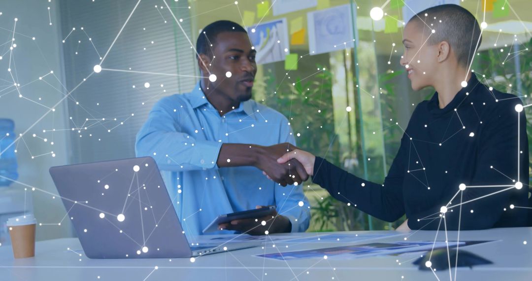 Business Partners Shaking Hands in Modern Workspace