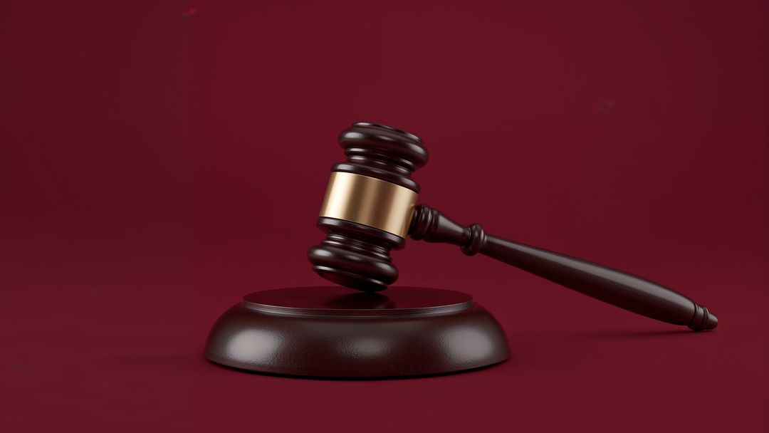 Judges Gavel on Deep Red Background Symbolizing Justice