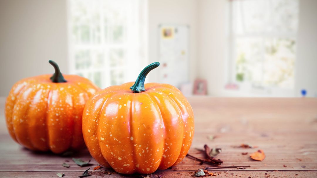 Vibrant Pumpkins on Wooden Table Evoking Cozy Autumn Atmosphere