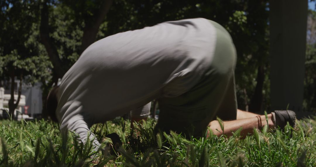 Man crawling through grass in park - Free Images, Stock Photos and Pictures on Pikwizard.com