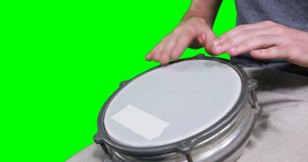 Mid section of drummer playing drum against green screen - Free Images, Stock Photos and Pictures on Pikwizard.com
