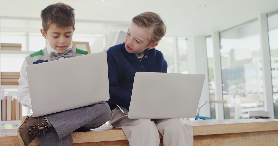 Children Collaborating on Laptops in Bright Modern Space - Free Images, Stock Photos and Pictures on Pikwizard.com