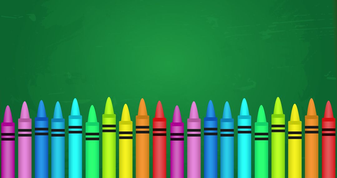 Colorful wax crayons lined up on green chalkboard background