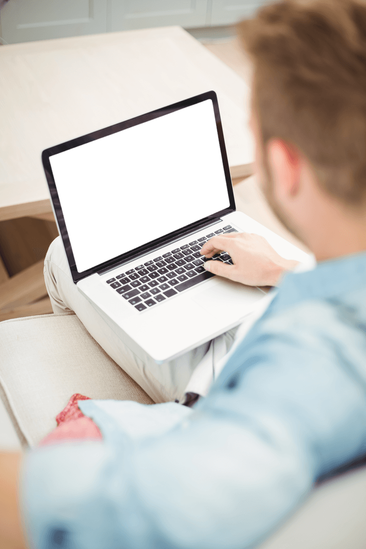 Young Man Using Laptop with Transparent Screen at Home