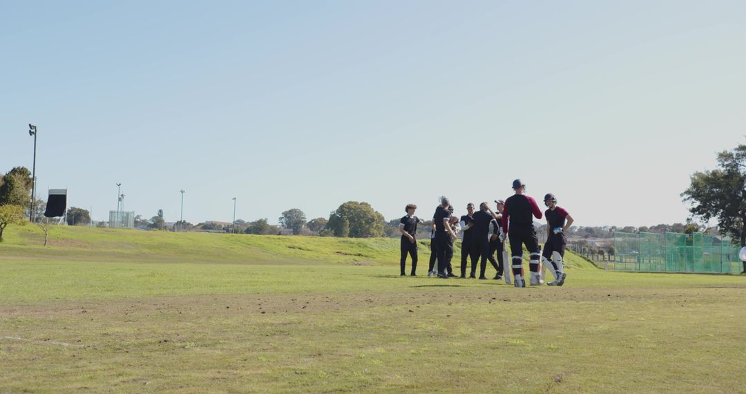 Cricket Players Gathering on Field for Strategy Discussion