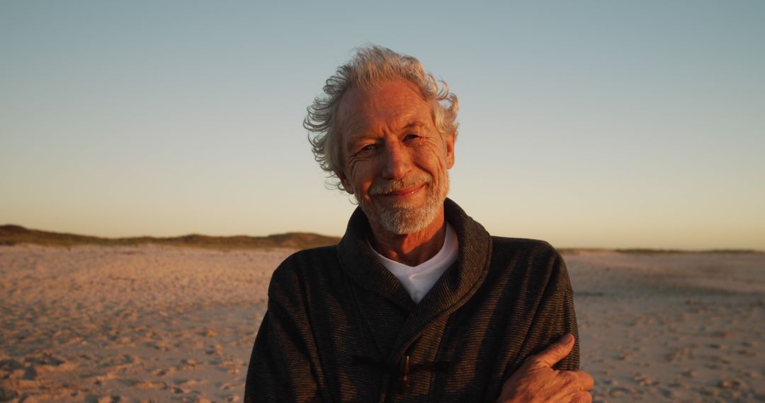 Smiling Elderly Man Enjoying Sunset on Beach - Free Images, Stock Photos and Pictures on Pikwizard.com