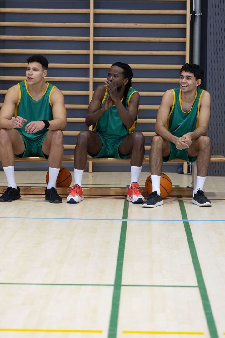 Diverse Basketball Players in Gym Sitting on Bench