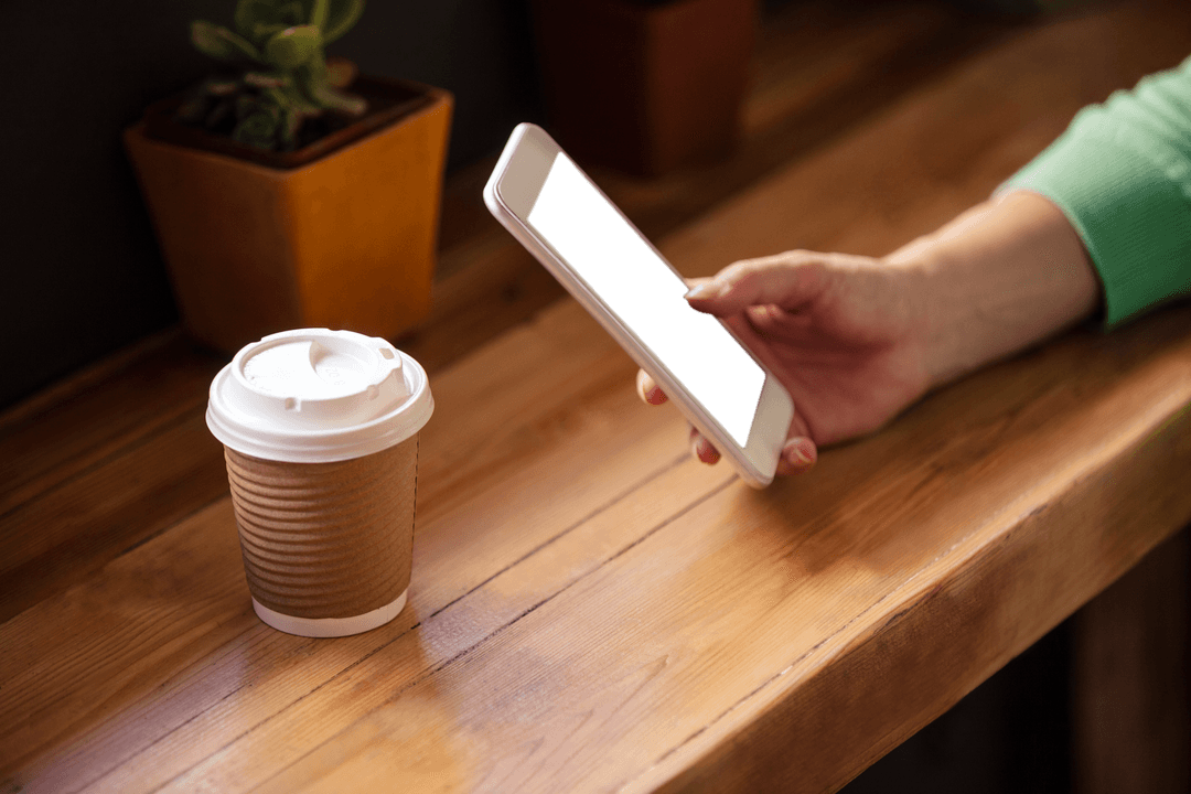 Transparent Smartphone Usage at Coffee Table with Coffee Cup
