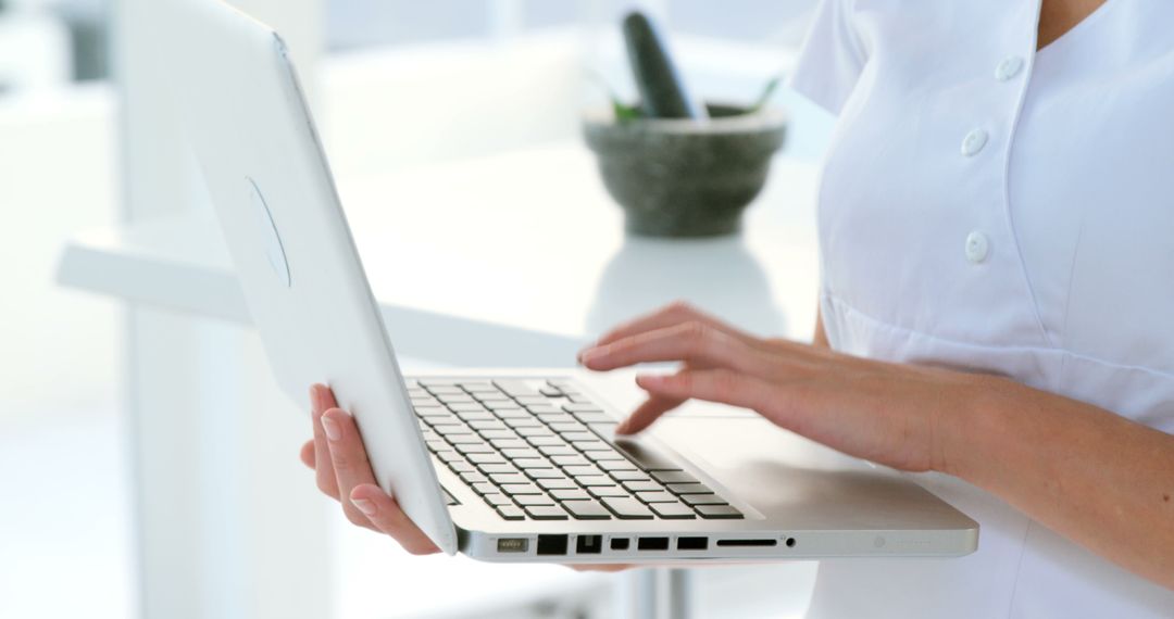 Health Professional Typing on Laptop in Medical Office - Free Images, Stock Photos and Pictures on Pikwizard.com