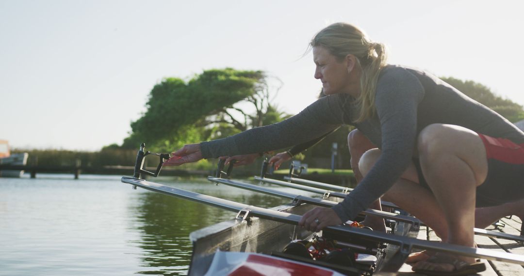 Female Team Prepares for Rowing Practice on Tranquil Lake - Free Images, Stock Photos and Pictures on Pikwizard.com