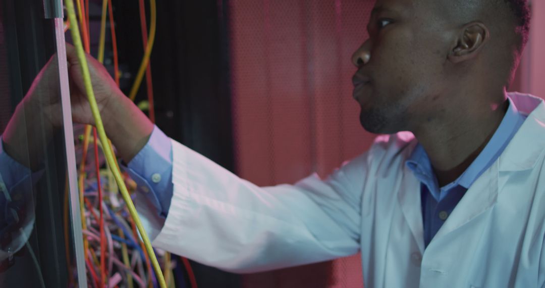 African American IT Technician Configuring Server Cables in Data Center - Free Images, Stock Photos and Pictures on Pikwizard.com