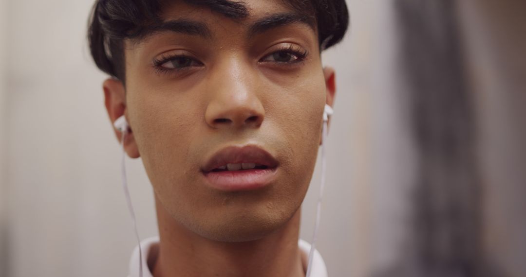 Close-Up of Young Man Wearing Earphones - Free Images, Stock Photos and Pictures on Pikwizard.com