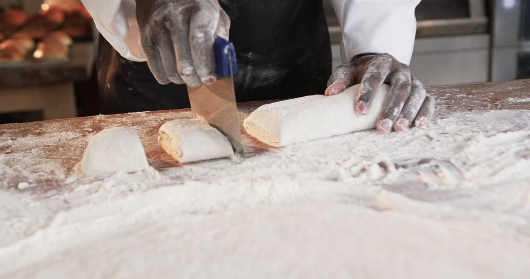 Baker Slicing Dough on Floured Surface in Professional Kitchen - Free Images, Stock Photos and Pictures on Pikwizard.com