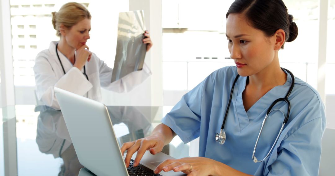 Medical Professionals Reviewing Patient Records in Modern Office - Free Images, Stock Photos and Pictures on Pikwizard.com