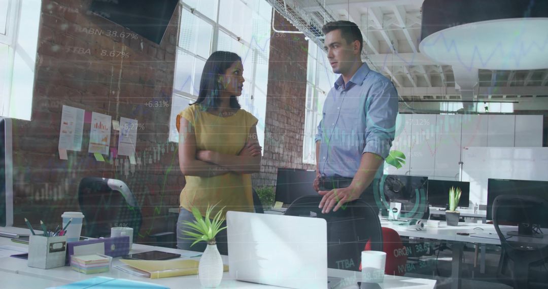 Discussing Project in Modern Open-Plan Office with Laptop and Brick Accent