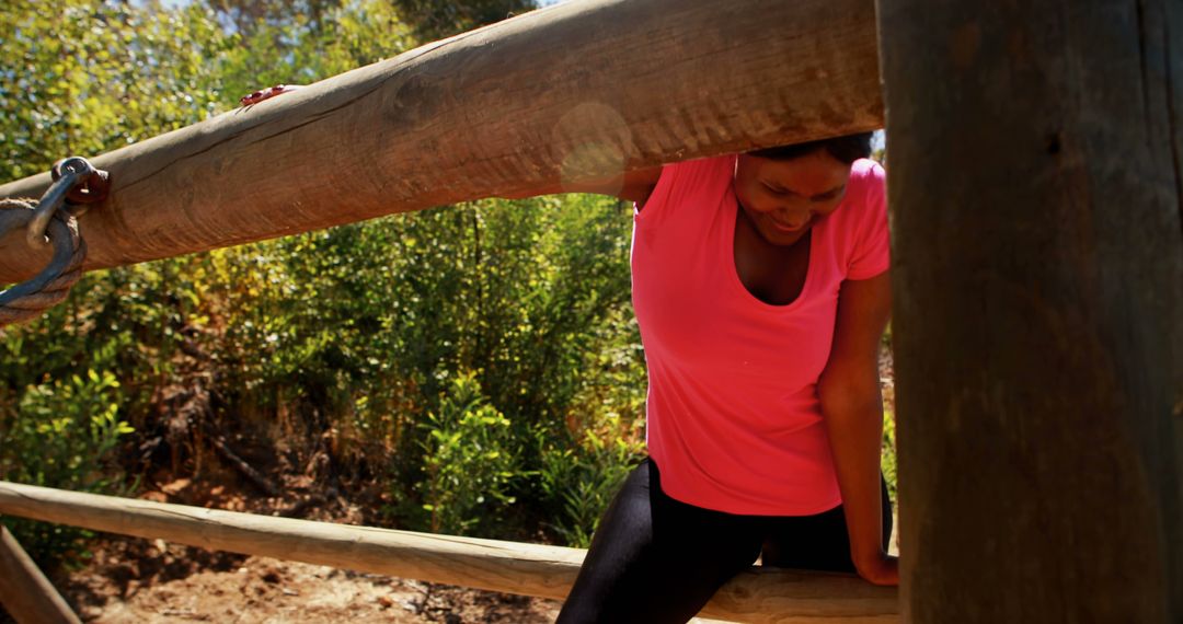 Woman Overcoming Wooden Obstacle in Outdoor Training Course - Free Images, Stock Photos and Pictures on Pikwizard.com