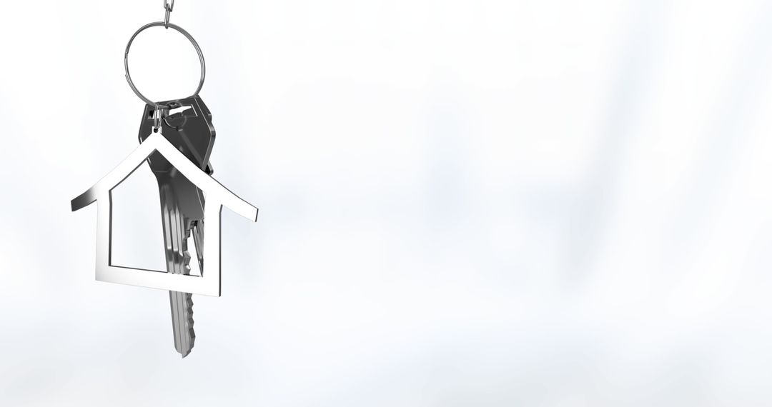 Keychain with Silver House-Shaped Charm Hanging on Light Background