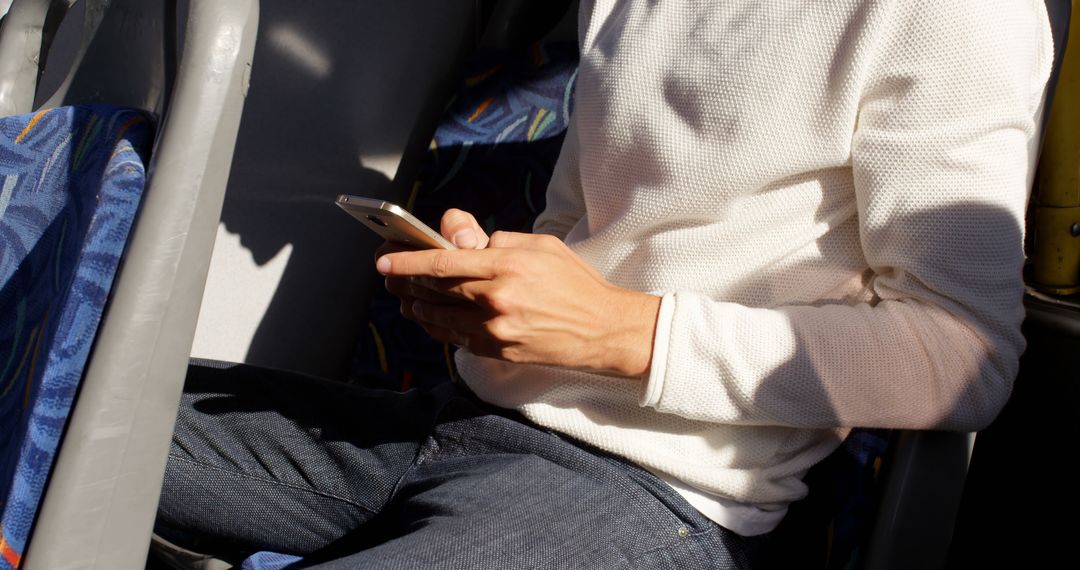 Person Sitting on Bus Using Smartphone in Casual Outfit - Free Images, Stock Photos and Pictures on Pikwizard.com