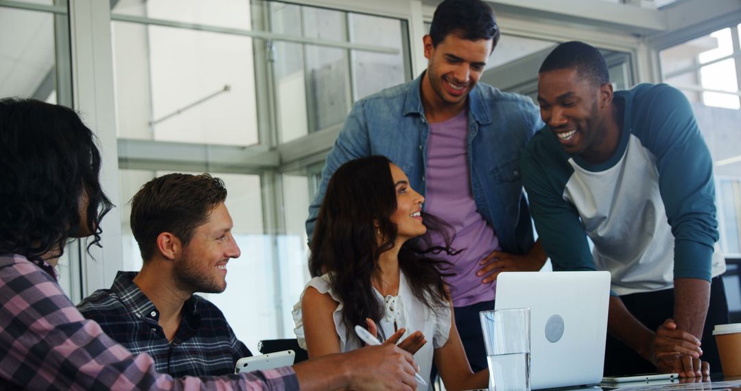 Diverse Team Collaborating in Modern Office with Lively Interaction