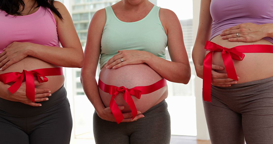 Group of Pregnant Women with Red Ribbons on Bellies - Free Images, Stock Photos and Pictures on Pikwizard.com