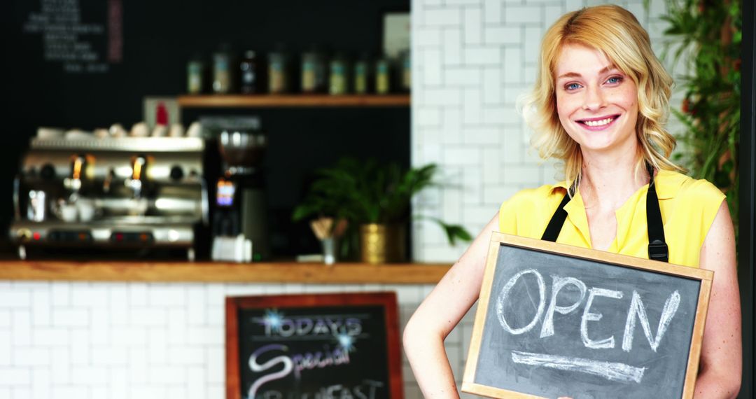 Smiling Cafe Owner Holding Open Sign Inside Coffee Shop - Free Images, Stock Photos and Pictures on Pikwizard.com