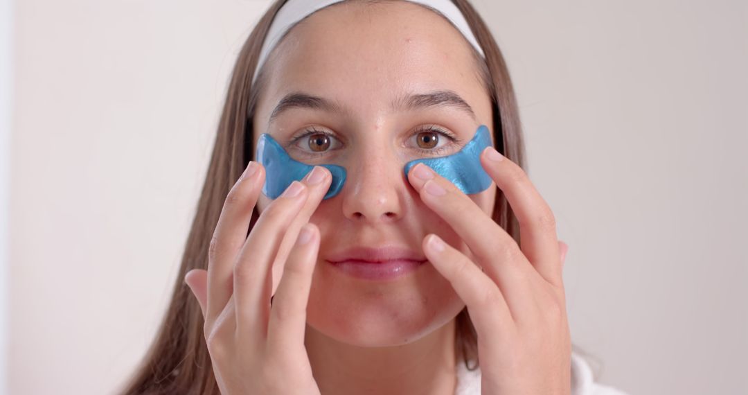 Woman Using Blue Gel Eye Patches for Skincare Routine