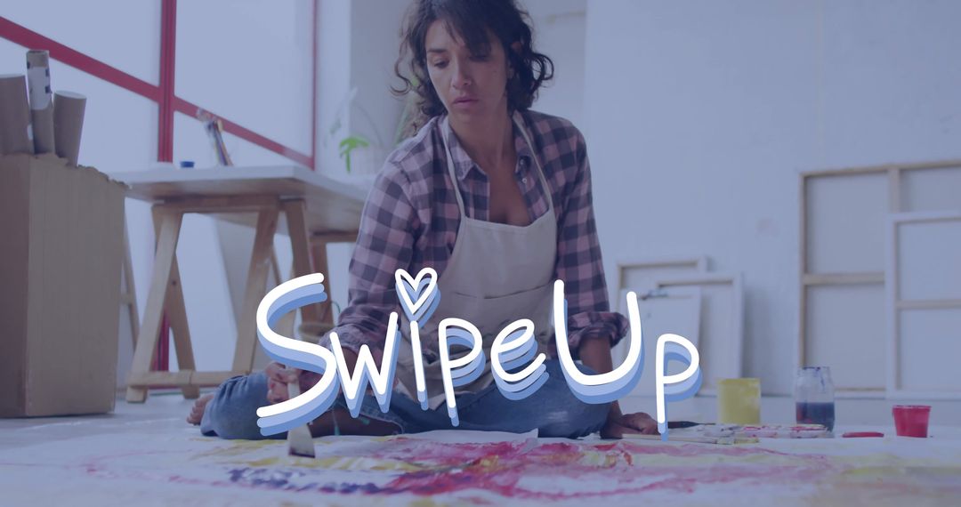 Female Artist Creating Colorful Floor Canvas in Studio Workshop