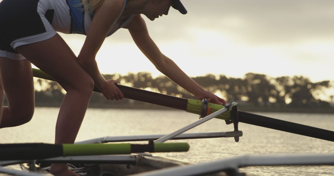 Female Rower Preparing Before Race on Tranquil Lake - Free Images, Stock Photos and Pictures on Pikwizard.com