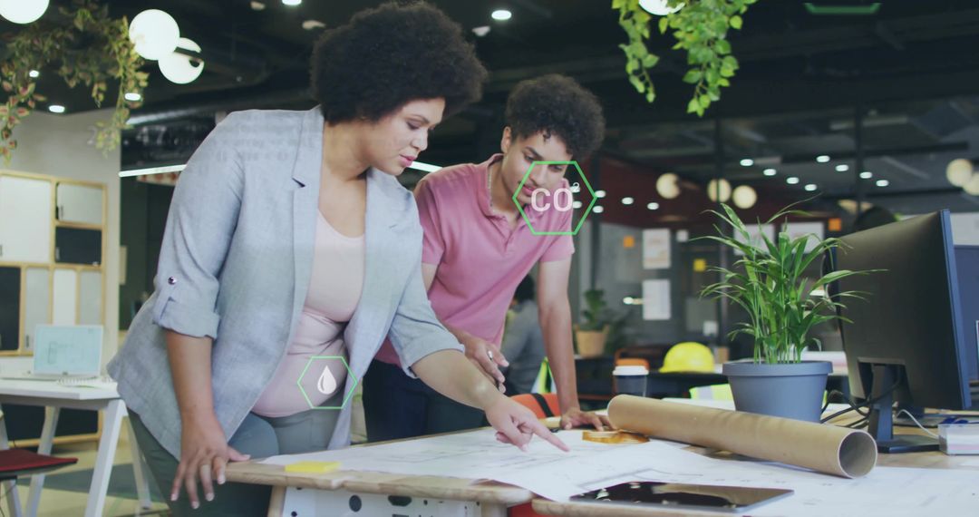 Architectural Team Analyzing Blueprints in Modern Office Workspace