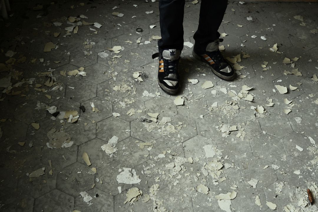 Person Standing on Floor with Peeling Paint and Debris - Free Images, Stock Photos and Pictures on Pikwizard.com