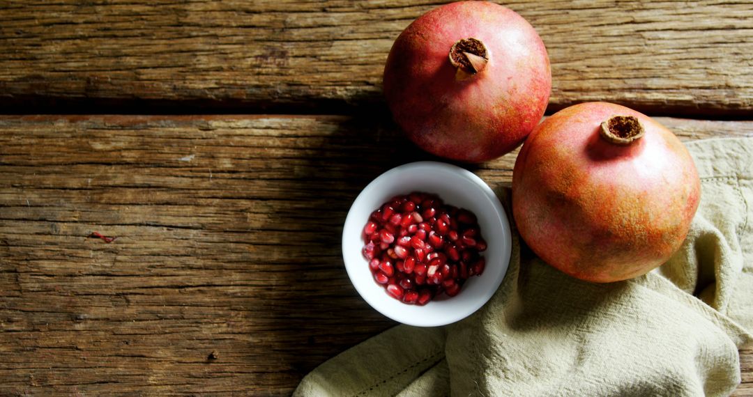 Whole Pomegranates and Seeds on Rustic Wooden Table - Free Images, Stock Photos and Pictures on Pikwizard.com