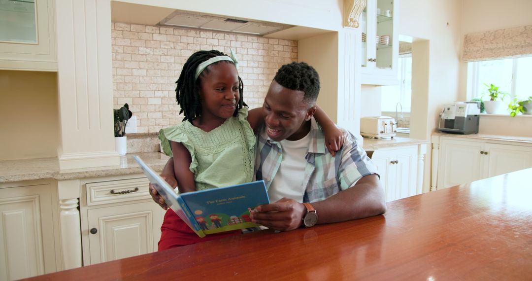 Father and Daughter Sharing Quality Time Reading Together in Kitchen
