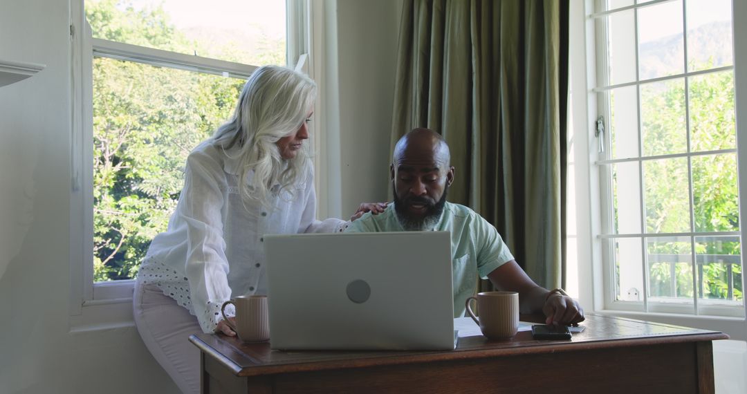 Couple Planning Wedding Day Together Using Technology at Home