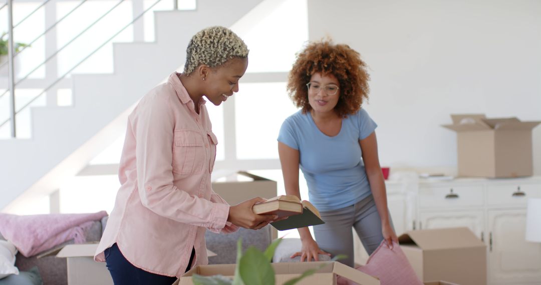 Two Smiling African American Women Unpacking Boxes in New Home - Free Images, Stock Photos and Pictures on Pikwizard.com