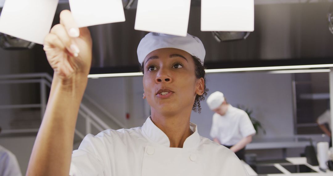 Professional Chef Organizing Orders in Busy Restaurant Kitchen - Free Images, Stock Photos and Pictures on Pikwizard.com