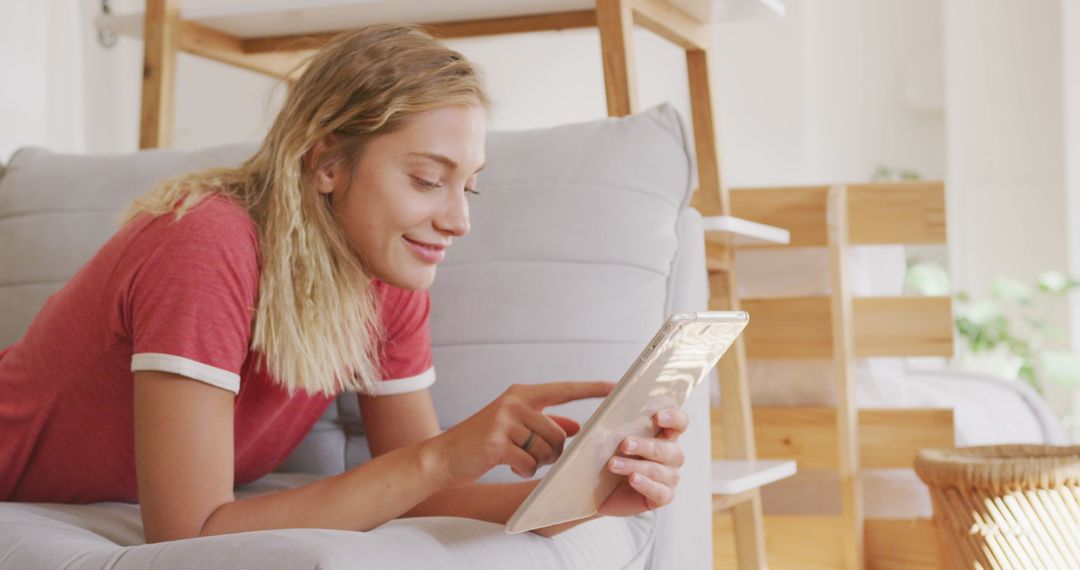 Young Woman Enjoying a Relaxed Weekend at Home Using Tablet