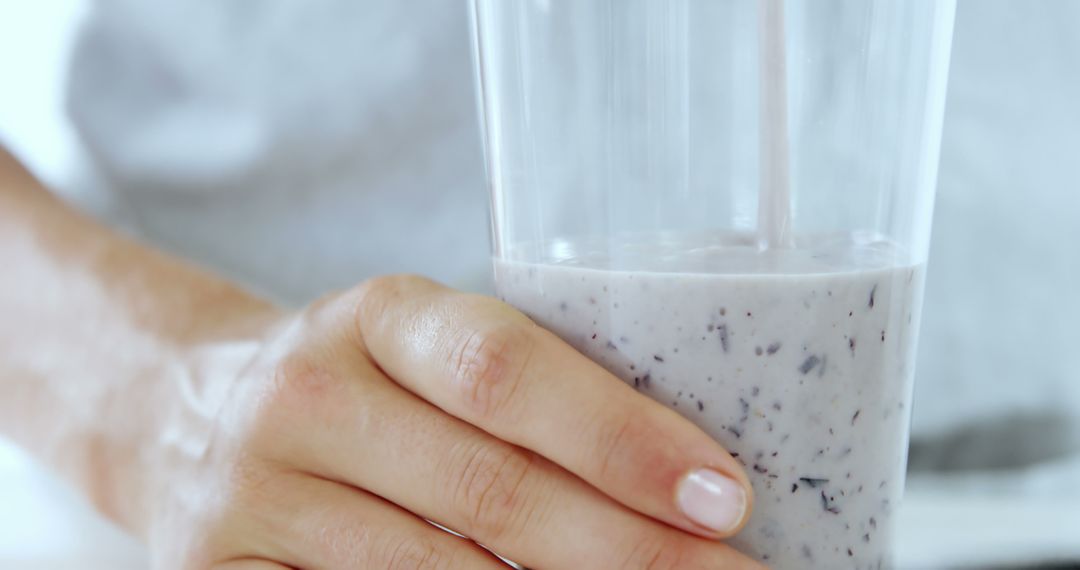 Hand Holding Glass of Healthy Blueberry Smoothie - Free Images, Stock Photos and Pictures on Pikwizard.com