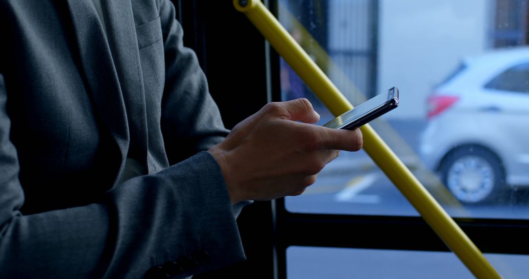 Business Professional Texting on Mobile Phone Inside Public Bus - Free Images, Stock Photos and Pictures on Pikwizard.com