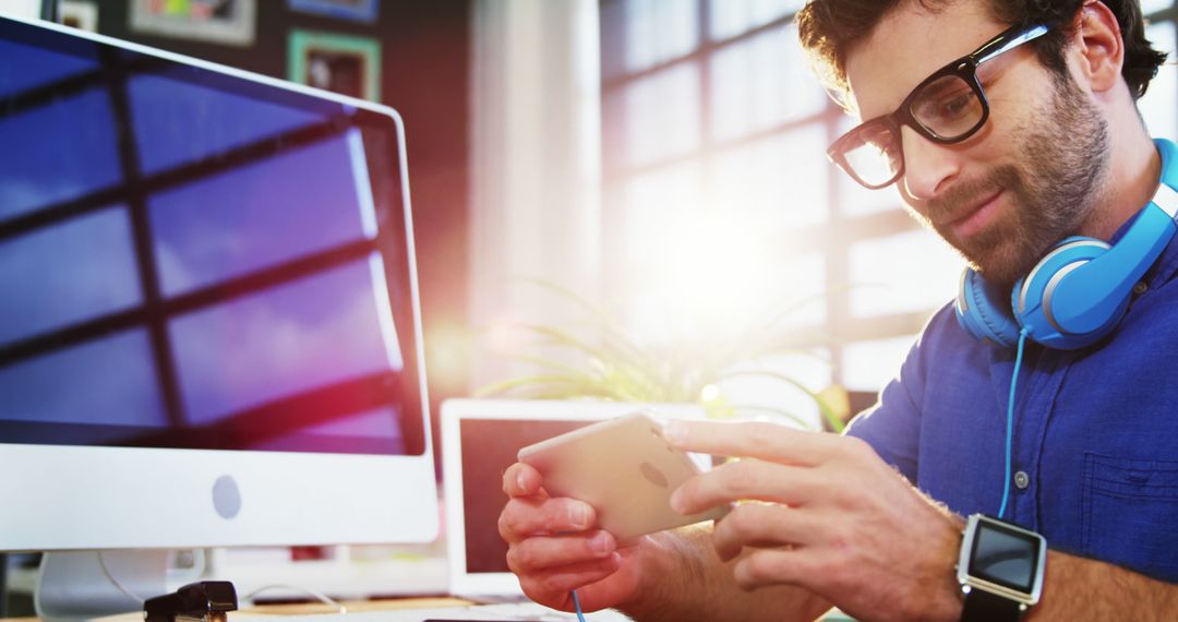 Business Executive Multitasking with Smartphone at Modern Workspace