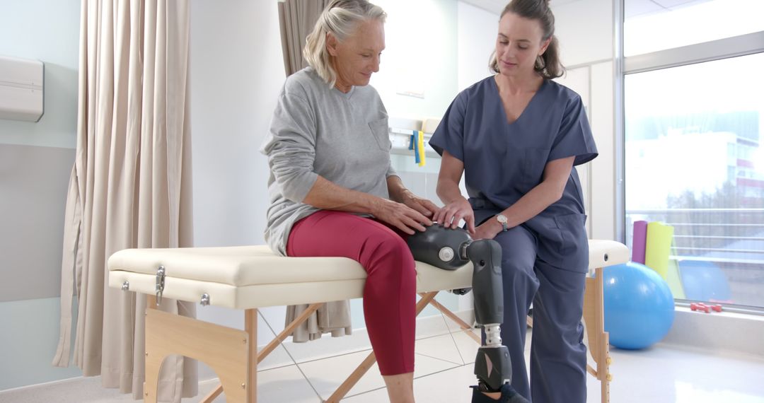 Nurse Assisting Senior Woman with Prosthetic Leg in Rehabilitation Center - Free Images, Stock Photos and Pictures on Pikwizard.com