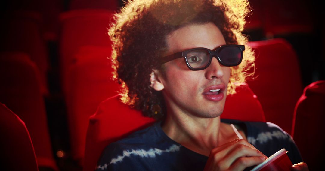 Curly-Haired Man Enjoying 3D Movie in Theater - Free Images, Stock Photos and Pictures on Pikwizard.com