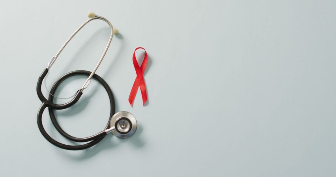 Image of stethoscope and red blood cancer ribbon on pale blue background - Free Images, Stock Photos and Pictures on Pikwizard.com